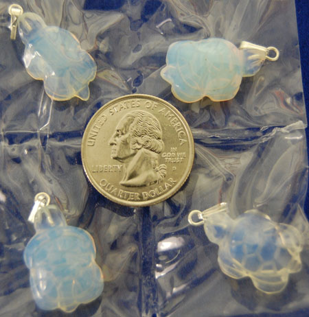 Image of opalite pendants shaped as slim arrowheads